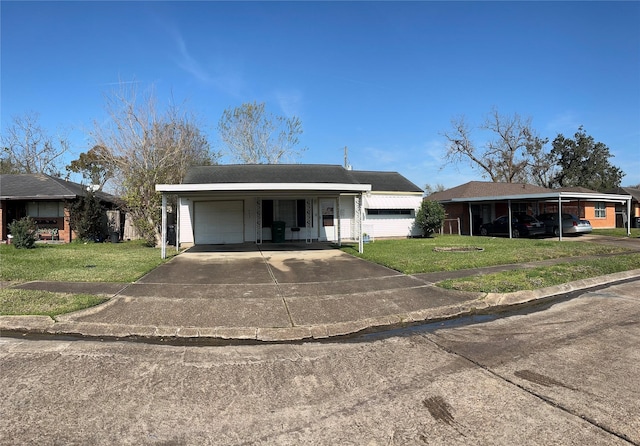 single story home with a front yard, a garage, and a carport