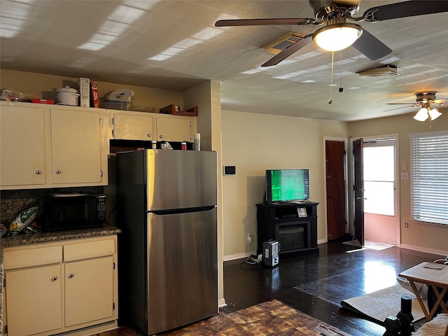 kitchen featuring white cabinets, backsplash, stainless steel refrigerator, and ceiling fan