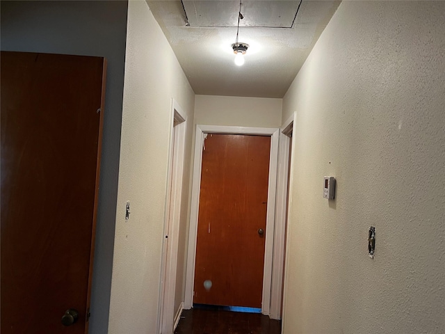 hallway with a textured ceiling