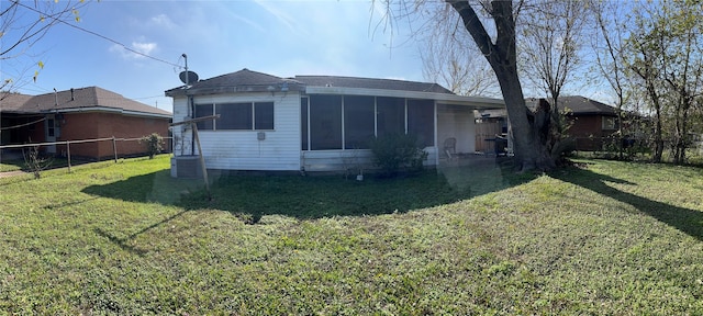 rear view of house with a lawn