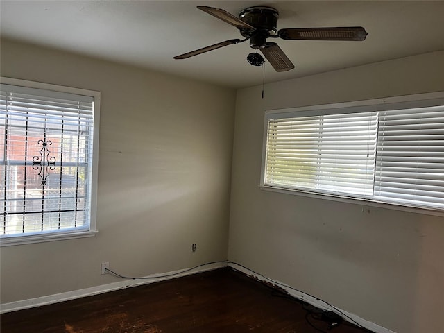 spare room with ceiling fan and dark hardwood / wood-style flooring