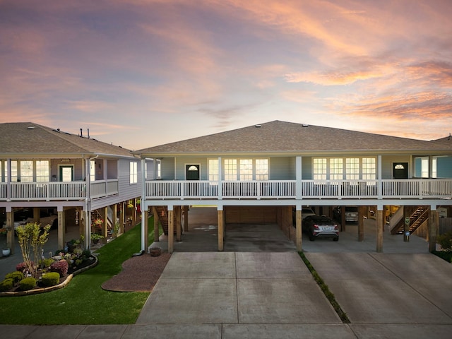 back house at dusk with a carport