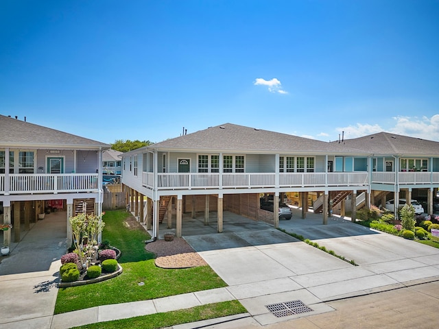 view of front of house with a front yard and a carport