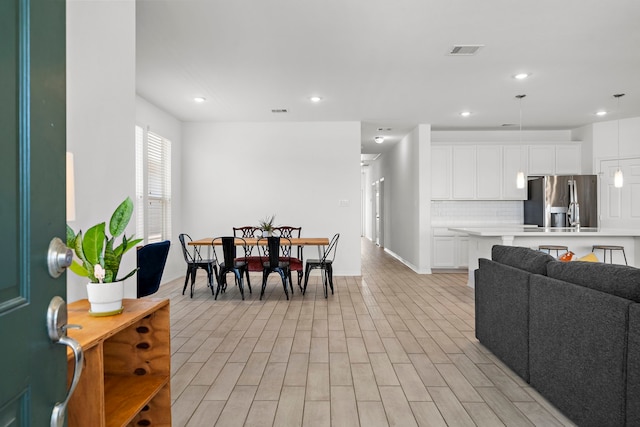 dining room featuring light wood-type flooring and sink