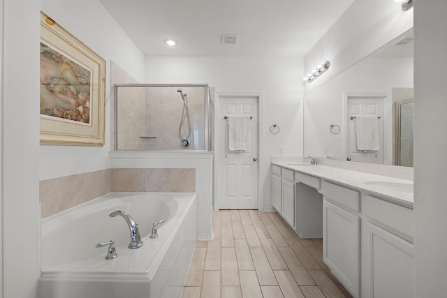 bathroom featuring plus walk in shower and vanity