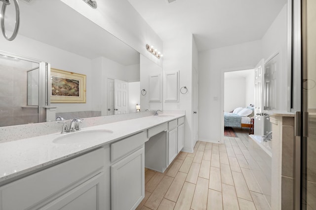 bathroom featuring vanity and an enclosed shower