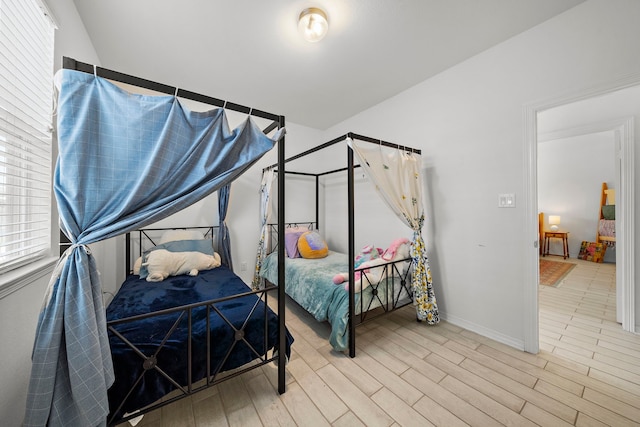 bedroom featuring multiple windows and hardwood / wood-style floors