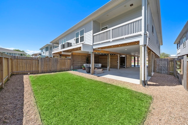 back of property with a patio area and a yard