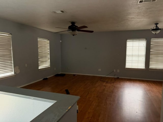 spare room with hardwood / wood-style floors and ceiling fan