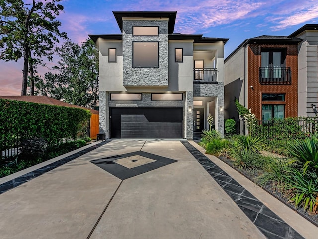 contemporary house featuring a balcony and a garage