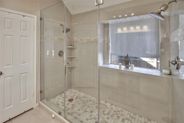 bathroom featuring tile patterned floors and an enclosed shower