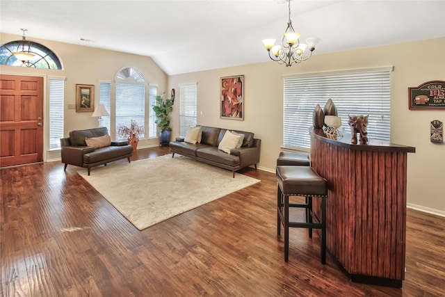 living room featuring lofted ceiling, dark wood-type flooring, and a notable chandelier