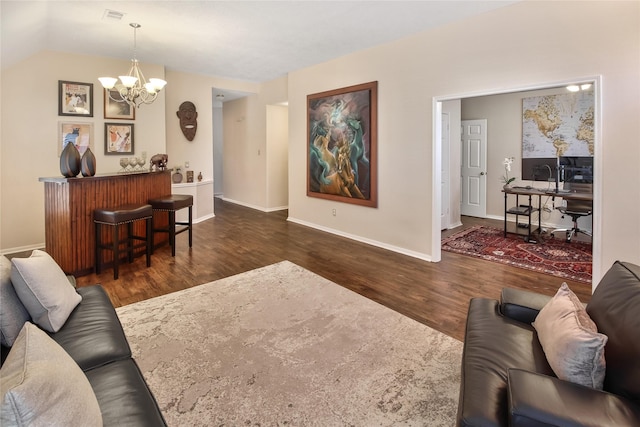 living room featuring lofted ceiling, dark hardwood / wood-style flooring, and a notable chandelier