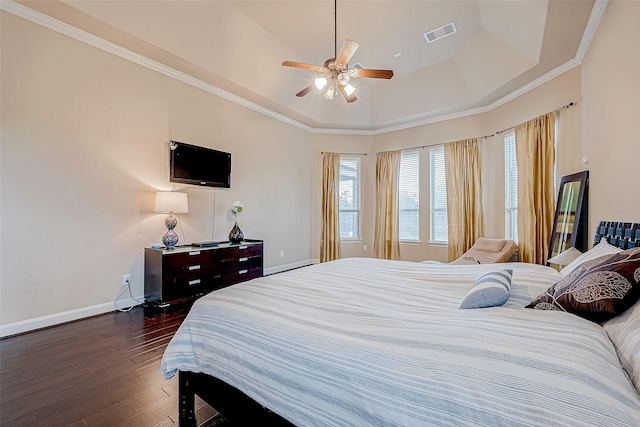 bedroom featuring a raised ceiling, ceiling fan, dark hardwood / wood-style floors, and ornamental molding