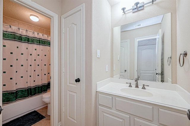 bathroom with tile patterned floors, vanity, and toilet