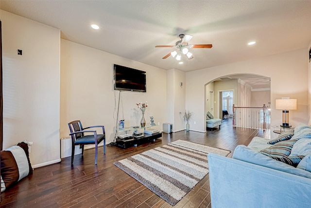 living room with dark hardwood / wood-style flooring and ceiling fan