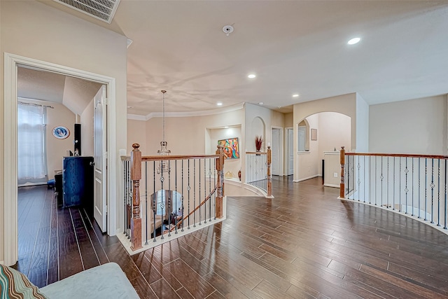 corridor featuring dark hardwood / wood-style floors and ornamental molding