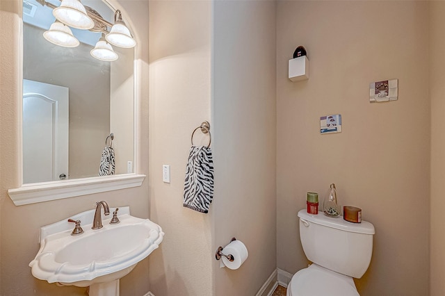 bathroom featuring toilet and sink