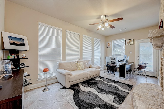 living room with ceiling fan and light tile patterned floors