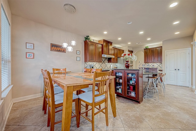 dining space featuring light tile patterned flooring