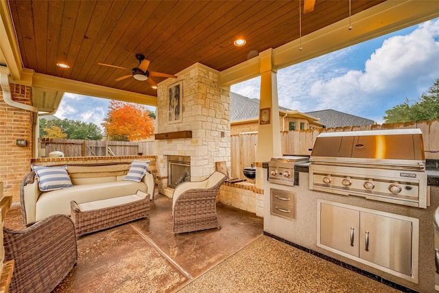 view of patio / terrace featuring an outdoor living space with a fireplace, ceiling fan, exterior kitchen, and a grill