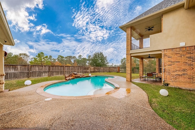 view of pool with ceiling fan, a yard, and a patio