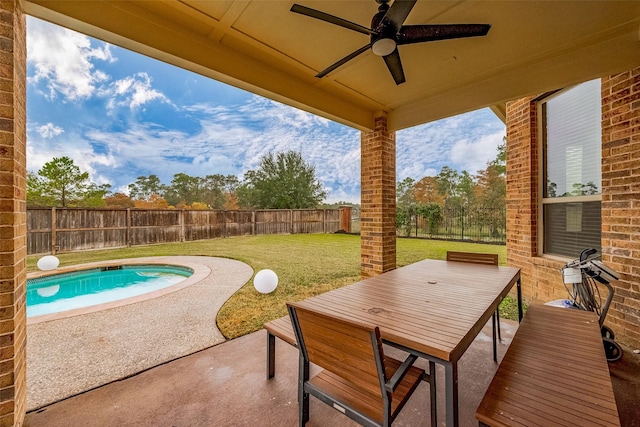 view of patio / terrace with a fenced in pool and ceiling fan