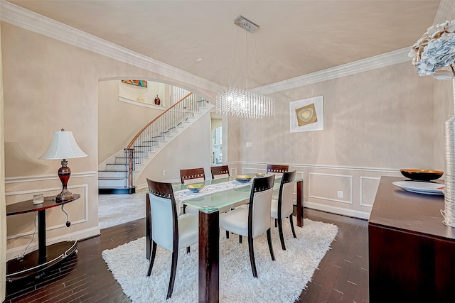 dining room featuring a chandelier, dark hardwood / wood-style floors, and ornamental molding