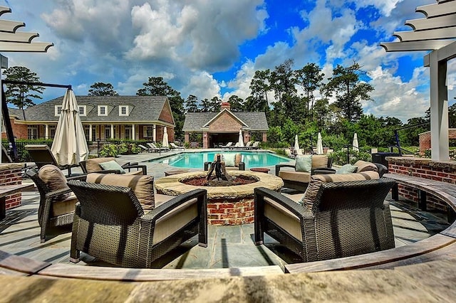 view of pool featuring an outbuilding and a patio