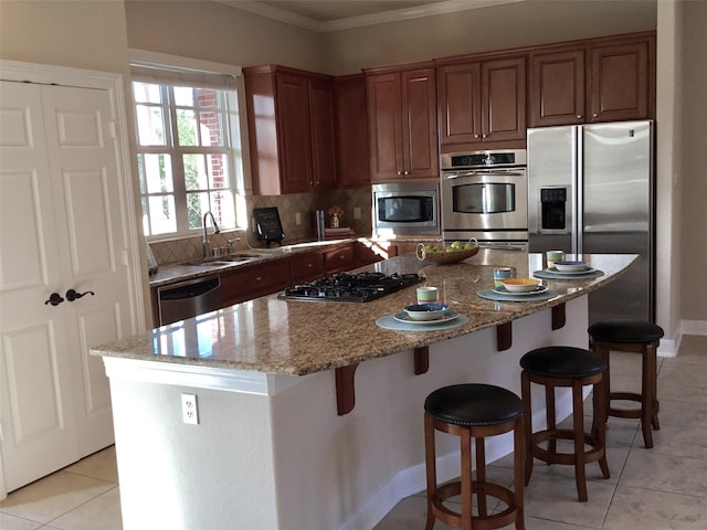 kitchen with a kitchen island, stainless steel appliances, tasteful backsplash, light tile patterned flooring, and light stone counters