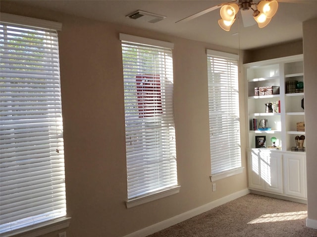 interior space with ceiling fan and carpet flooring