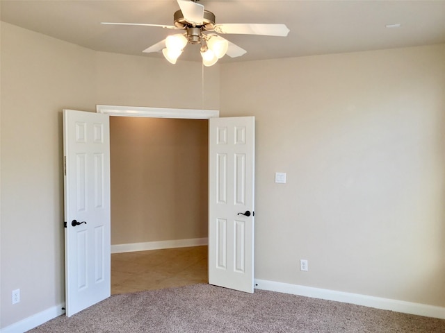 unfurnished bedroom featuring ceiling fan and light colored carpet