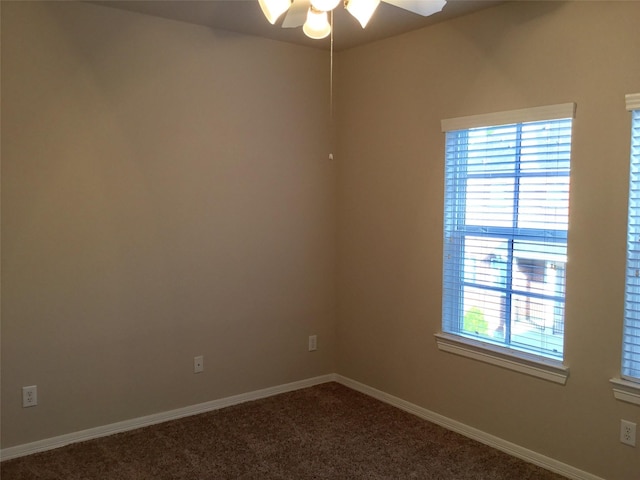 carpeted spare room featuring ceiling fan