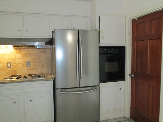 kitchen with black oven, white cabinetry, stainless steel refrigerator, and white gas cooktop