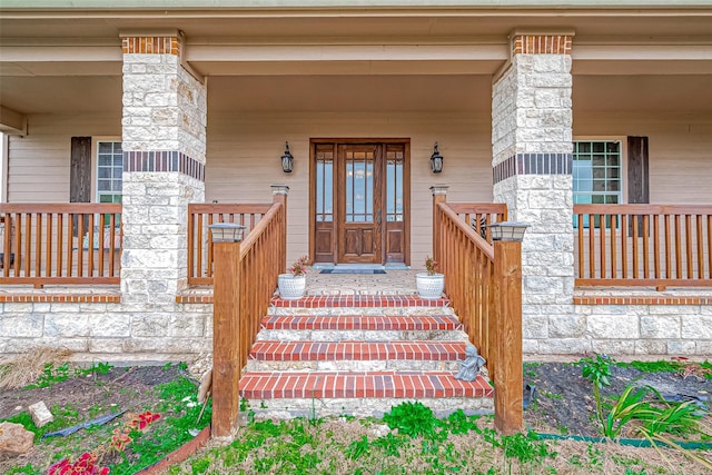 doorway to property featuring covered porch