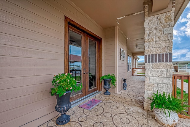 property entrance with a porch and french doors