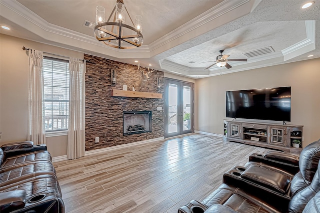 living room featuring hardwood / wood-style floors, a raised ceiling, and crown molding