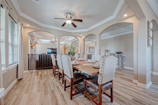 dining room with light wood-type flooring, ceiling fan, and ornamental molding