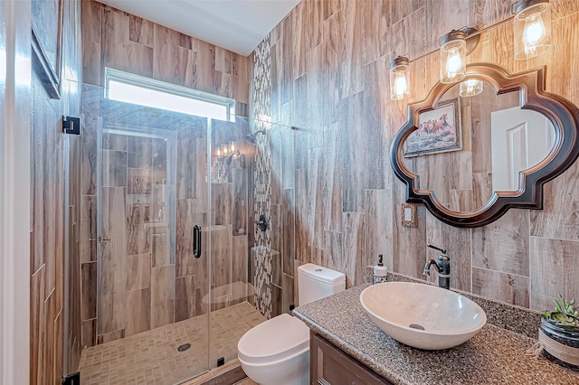 bathroom with an enclosed shower, vanity, and toilet