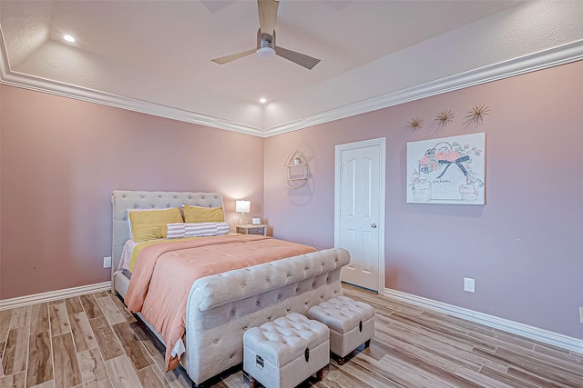 bedroom featuring hardwood / wood-style floors, ceiling fan, and crown molding