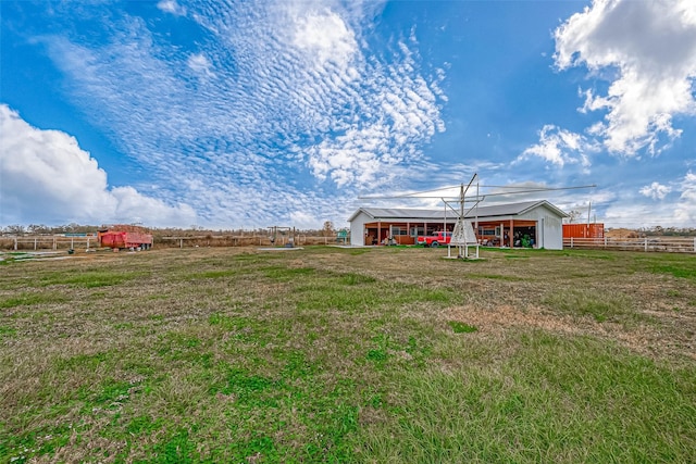 view of yard with a rural view and an outdoor structure