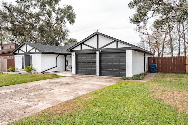 view of front of house featuring a garage and a front lawn