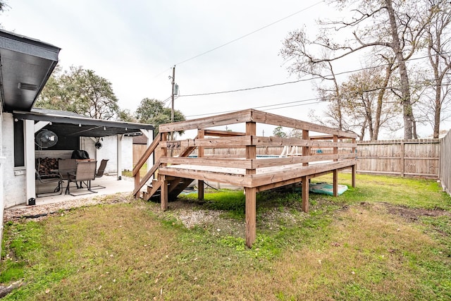 wooden deck with a patio area and a lawn