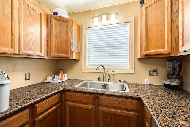 kitchen with dark stone countertops and sink