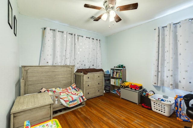 bedroom with ceiling fan and dark wood-type flooring