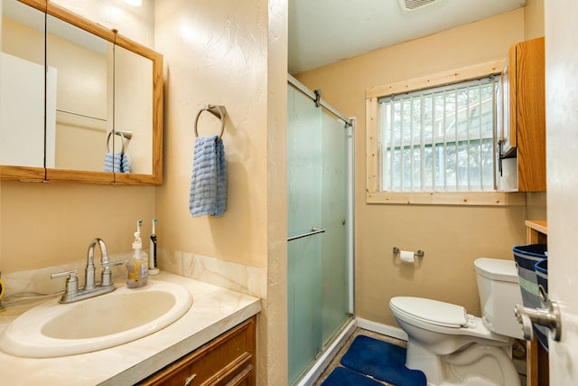 bathroom with vanity, toilet, and an enclosed shower