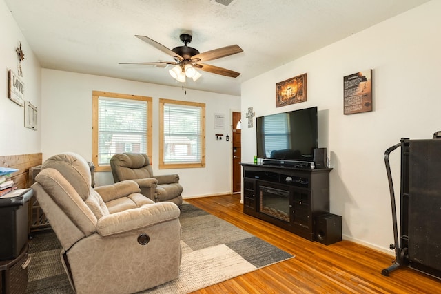 living room with hardwood / wood-style flooring and ceiling fan