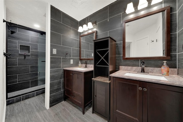 bathroom with vanity and tile walls