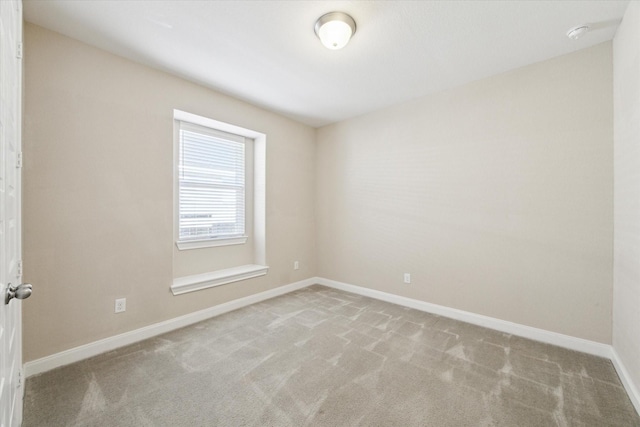 unfurnished room featuring light colored carpet