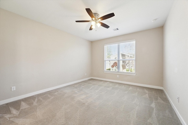 spare room with light colored carpet and ceiling fan